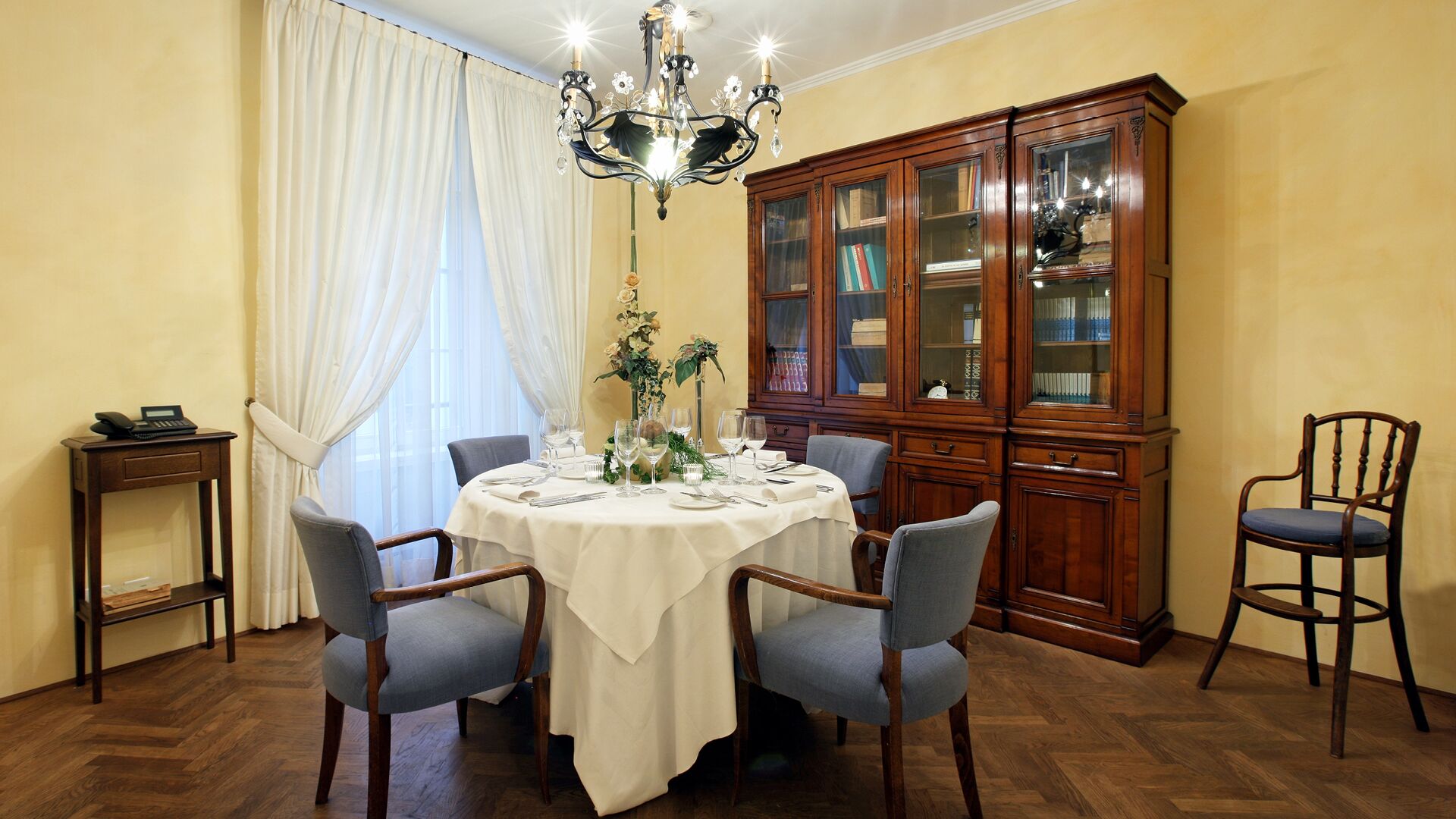 a dining room table with chairs and a chandelier